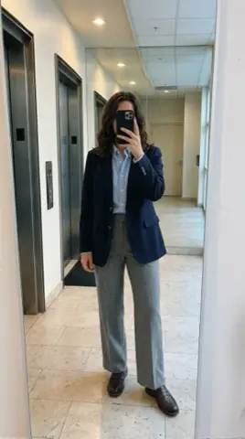fit pic: navy blazer, light blue oxford, grey trousers and brown loafers, in an office lobby mirror.